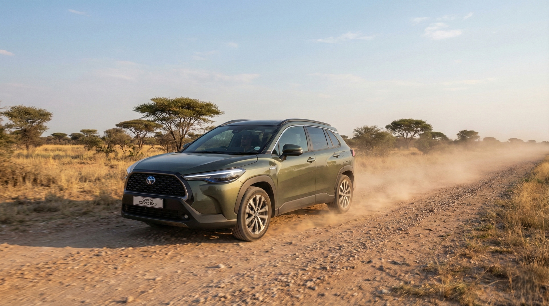 Toyota Corolla Cross Hybrid XS driving on a gravel road in rural Botswana with savanna scenery